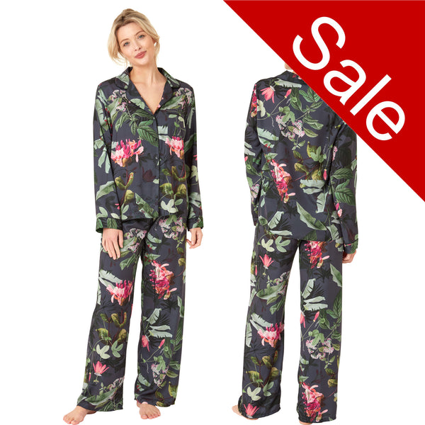 Black full floral tropical print mat satin pjs set consisting of a shirt style top with a collar, top pocket and button up front with matching full length trousers with an elasticated waist band in UK plus size 14, 16, 18, 20, 22, 24, 26, 28