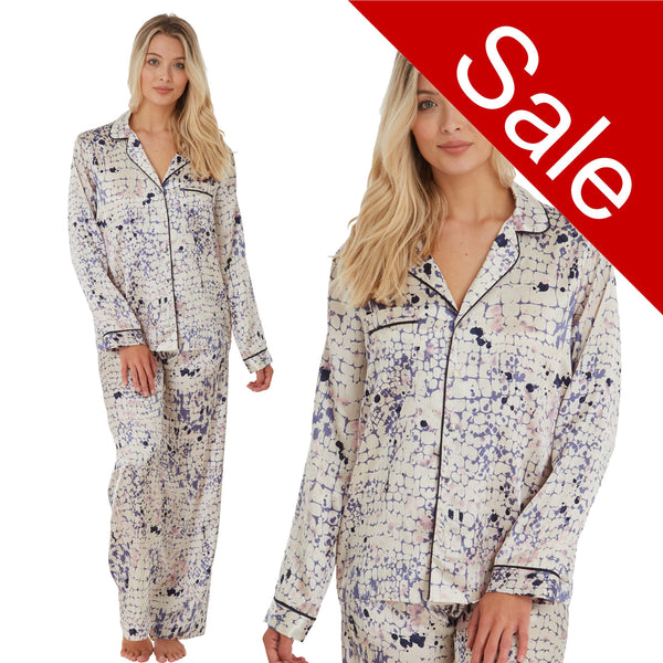 ivory background with a blue animal print silky shiny satin pjs set consisting of a shirt style top with full length sleeves, a collar, top pocket and a button up front with matching full length trousers in UK size 14, 16, 