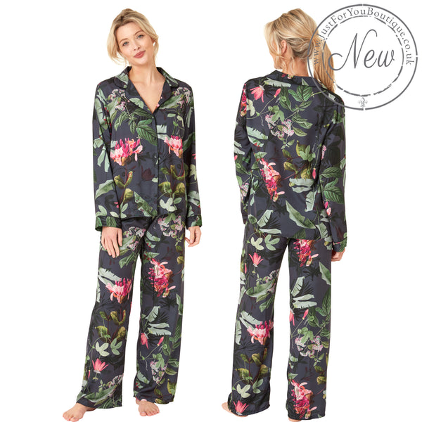 Black full floral tropical print mat satin pjs set consisting of a shirt style top with a collar, top pocket and button up front with matching full length trousers with an elasticated waist band in UK plus size 18, 20, 22, 24, 26, 28