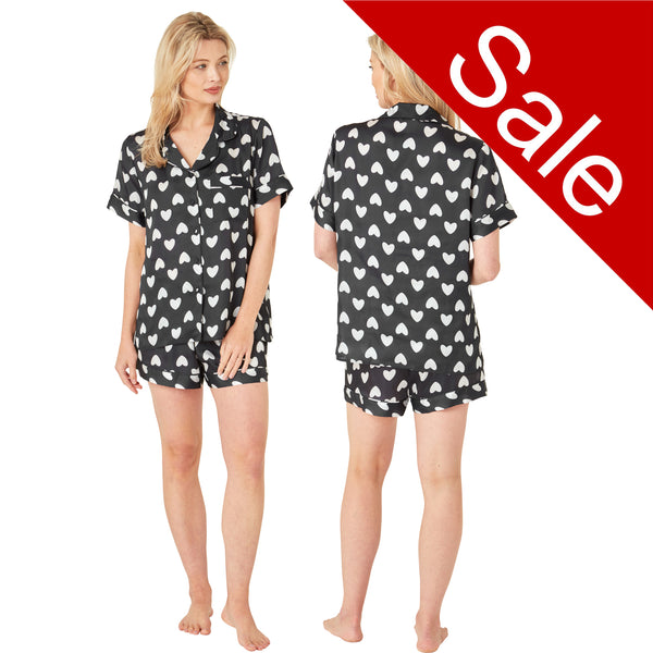 Black and white cute heart print satin pjs set and they consist of a shirt style top with a collar, top pocket and button up front and short sleeves with matching shorts with an elasticated waist band. In UK size 10, 12, 14, 16, 18, 20