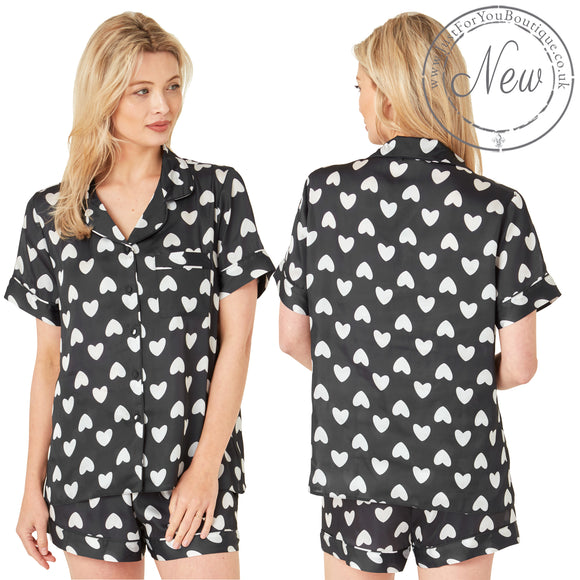 Black and white cute heart print satin pjs set and they consist of a shirt style top with a collar, top pocket and button up front and short sleeves with matching shorts with an elasticated waist band. In UK size 10, 12, 14, 16, 18, 20