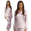 pink background with a darker pink poppy floral print silky shiny satin pjs set consisting of a shirt style top with full length sleeves, a collar, top pocket and a button up front with matching full length trousers in UK sizes 12, 14