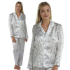 ivory background with a purple floral and hummingbird print silky shiny satin pjs set consisting of a shirt style top with full length sleeves, a collar, top pocket and a button up front with matching full length trousers in UK sizes 8, 10, 12, 14