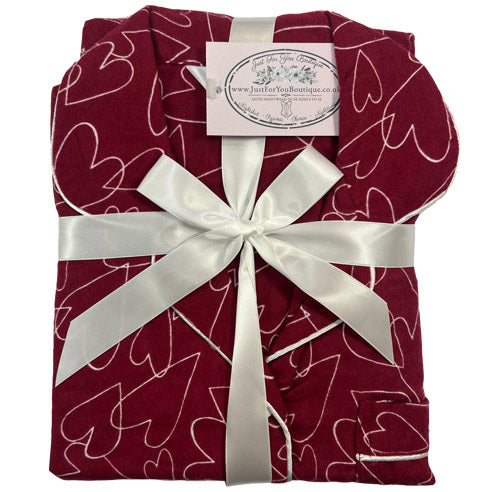 ladies red background with a heart print brushed cotton winter pyjamas pjs set with a shirt style which has a button front, collar and long sleeves and full length trousers in UK sizes 8, 10, 12, 14, 16, 18, 20