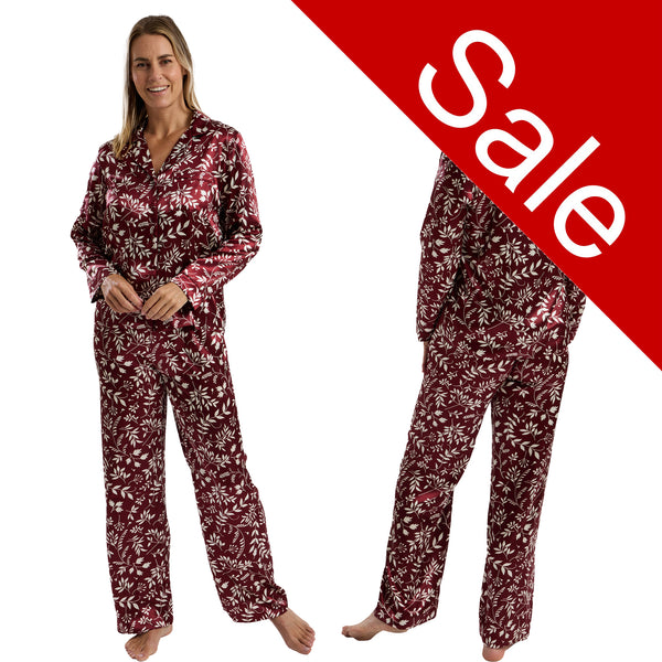Autumn burgundy cherry red leaf floral print shiny satin pjs set consisting of a shirt style top with a collar, top pocket and button up front with matching full length trousers with an elasticated waist band in UK size 14-16