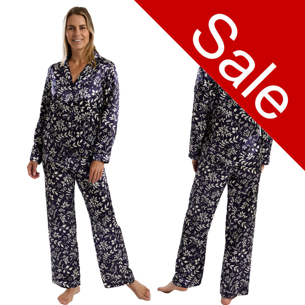 Autumn navy blue leaf floral print shiny satin pjs set consisting of a shirt style top with a collar, top pocket and button up front with matching full length trousers with an elasticated waist band in UK size 10-12