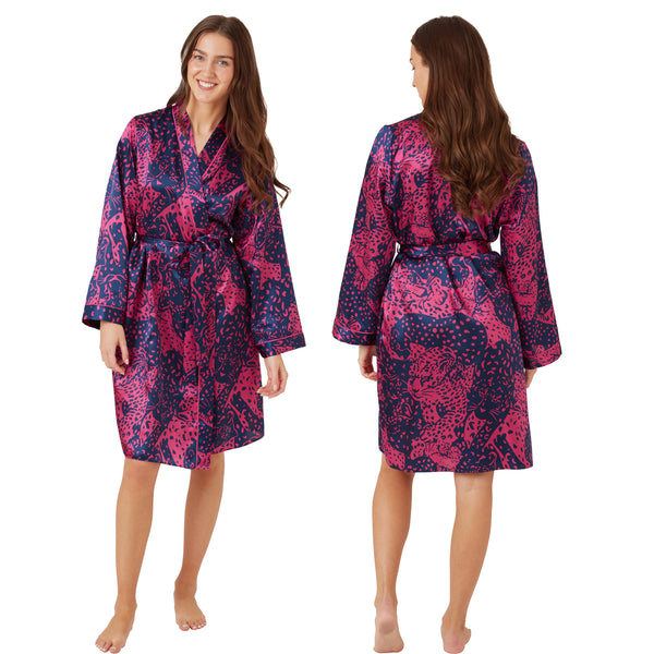 Hot pink oversized animal print style with a navy background in a silky shiny satin wrap, dressing gown, bathrobe, kimono which is knee length with adjustable straps and a vee neck detail in UK sizes 14, 16, 18, 20