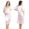 plain light pink shiny silky satin classic style mid length nightdress which is straight in fit with gathered fabric to the chest and elbow length sleeves. The chest and sleeves are trimmed with floral lace and it it available in UK plus sizes 8, 10, 12, 14, 16, 18, 20, 22, 24, 26, 28, 30, 32, 34
