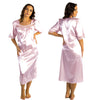 plain light pink shiny silky satin classic style mid length nightdress which is straight in fit with gathered fabric to the chest and elbow length sleeves. The chest and sleeves are trimmed with floral lace and it it available in UK plus sizes 8, 10, 12, 14, 16, 18, 20, 22, 24, 26, 28, 30, 32, 34