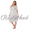 plain ivory white shiny silky satin classic style mid length nightdress which is straight in fit with gathered fabric to the chest and elbow length sleeves. The chest and sleeves are trimmed with floral lace and it it available in UK plus sizes 8, 10, 12, 14, 16, 18, 20, 22, 24, 26, 28, 30, 32, 34