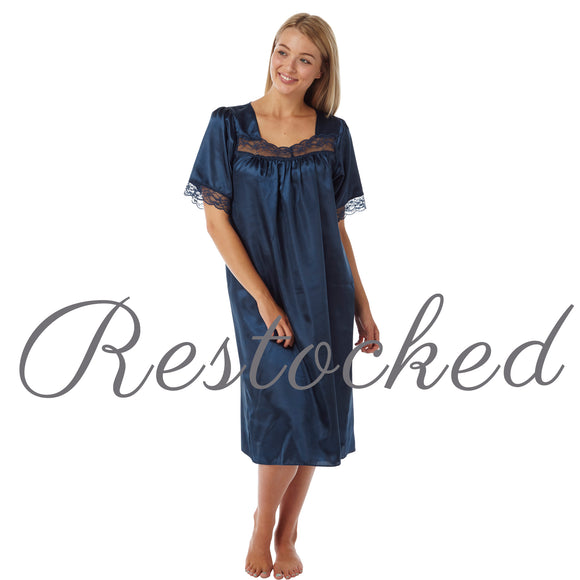 plain navy blue shiny silky satin classic style mid length nightdress which is straight in fit with gathered fabric to the chest and elbow length sleeves. The chest and sleeves are trimmed with floral lace and it it available in UK plus sizes 8, 10, 12, 14, 16, 18, 20, 22, 24, 26, 28, 30, 32, 34