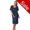 plain navy blue shiny silky satin classic style mid length nightdress which is straight in fit with gathered fabric to the chest and elbow length sleeves. The chest and sleeves are trimmed with floral lace and it it available in UK sizes 8, 10, 12, 14, 16, 18, 