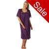 plain cadbury purple shiny silky satin classic style mid length nightdress which is straight in fit with gathered fabric to the chest and elbow length sleeves. The chest and sleeves are trimmed with floral lace and it it available in UK sizes 8, 10, 12, 14, 16, 18,