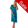 plain teal blue shiny silky satin classic style mid length nightdress which is straight in fit with gathered fabric to the chest and elbow length sleeves. The chest and sleeves are trimmed with floral lace and it it available in UK sizes 8, 10, 16, 18, 