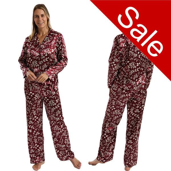 Autumn burgundy cherry red leaf floral print shiny satin pjs set consisting of a shirt style top with a collar, top pocket and button up front with matching full length trousers with an elasticated waist band in UK size 14-16