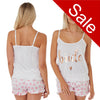 Bride pjs consiting of a cotton cami top with adjustable straps and satin shorts with a white background and pink hearts in UK sizes 8, 10, 16, 18